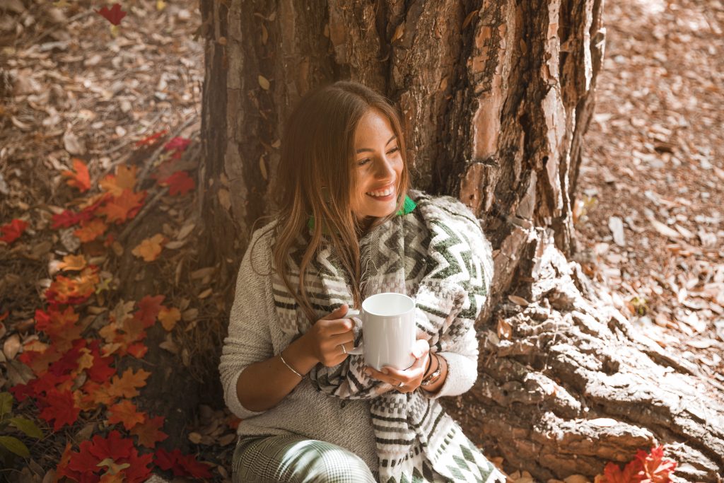 woman with drink enjoying weather autumn forest