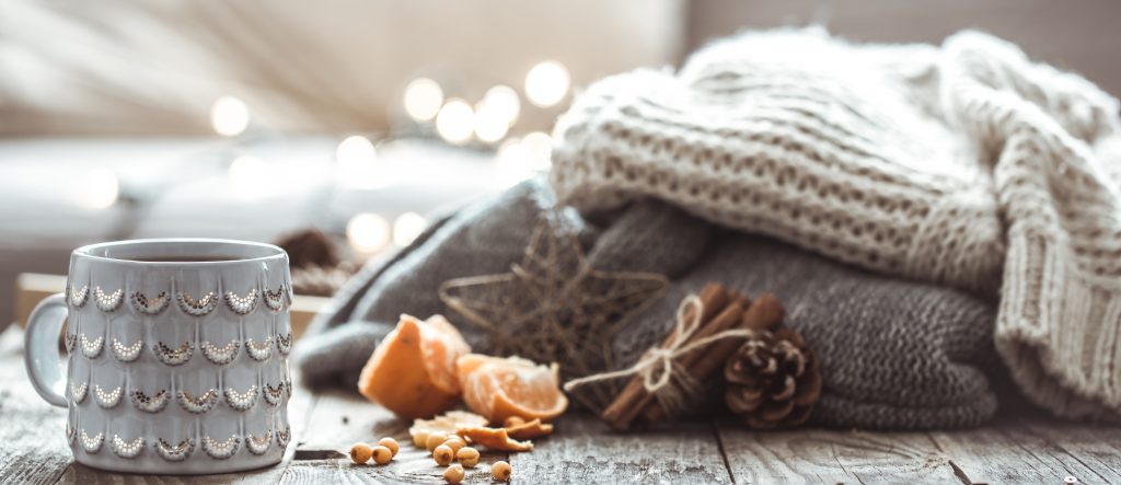 details still life home interior living room beautiful cup tea with tangerines sweaters wooden background cosy autumn winter concept
